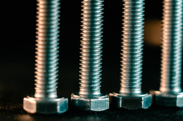 Closeup of the metal silver bolts against the dark background