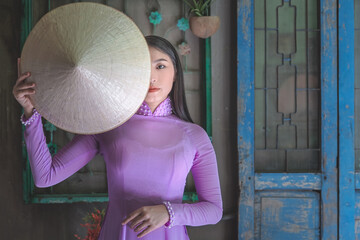 Young Vietnam woman wearing Ao Dai culture traditional at old temple at Ho Chi Minh in Vietnam,vintage style,travel and relaxing concept. - 458659186
