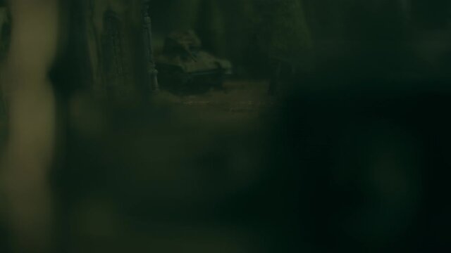 Toy tanks staging battle in ruined city with smoke effects. Macro view of T34 and Panther tanks. Models of famous tanks from WWII: Panther and T34