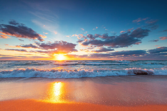 Beautiful sunrise over the sea water and beach