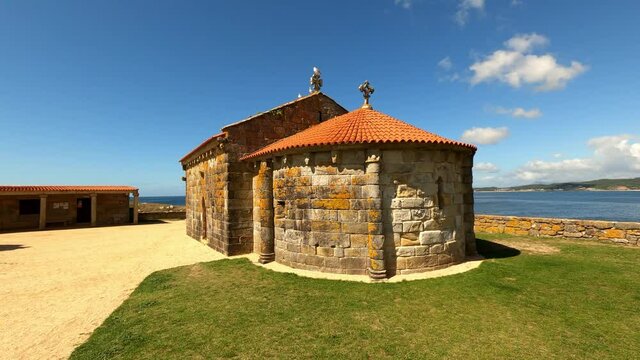 Traveling 180 degrees of the Romanesque chapel of la lanzada beach in galicia spain, showing the apse.
