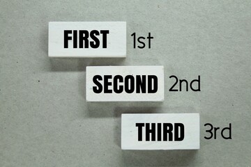 white cubes with the words first, second and third