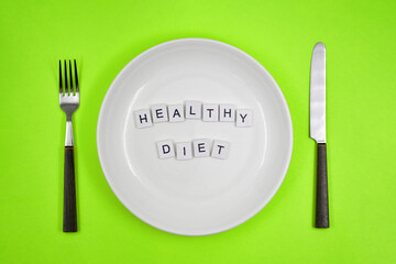 Conceptual photo, table setting with an empty plate, with one of the principles of healthy living - 
