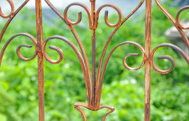 old rusty iron balcony wrought, blurred background tree nature