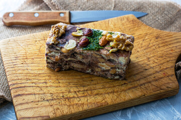 a piece of homemade tahini halva made of sesame on a wooden board close-up