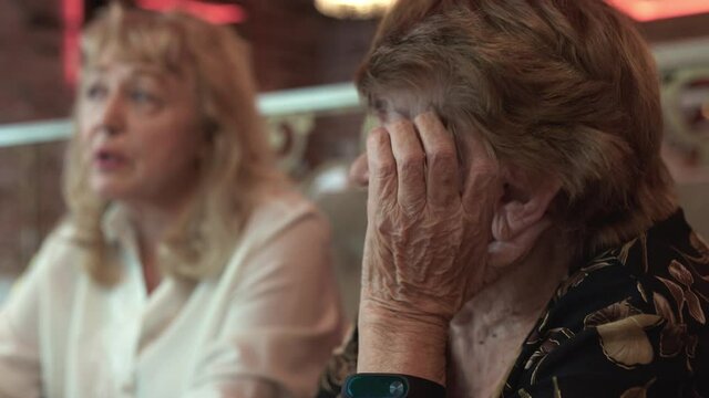 Senior relatives talking during family dinner