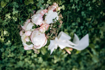 A wedding bouquet with pink and white peonies. The concept of a happy marriage.