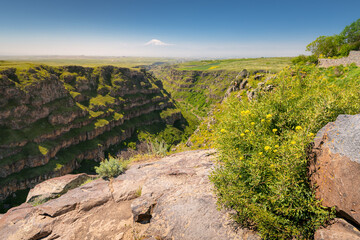 Scenic panorama view of the picturesque canyon and gorge carved into the rocks by the Kazakh River, with giant Ararat mount in Armenia