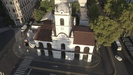 Aerial Drone flying up Cabildo building of Buenos Aires, Argentina. May Square, Famous Revolution's landmark, morning sun.
