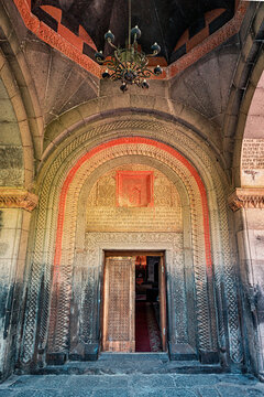 entrance portal to the ancient armenian Saint Gevorg Church with a wooden carved door. Religious and history concept