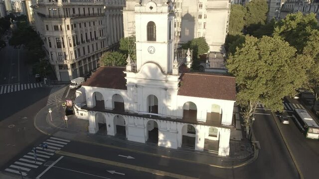 Aerial Drone flying around the Cabildo building of Buenos Aires, Argentina. May Square, Famous Revolution's landmark, morning sun.