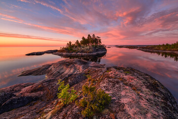 Rocky lake shore and clear water at dawn