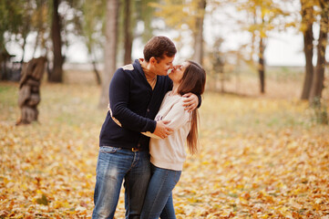 Lovely couple at autumn leaves park.