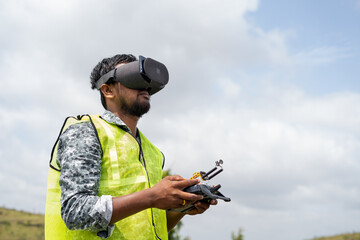Professional drone pilot controlling drone by looking into virtual reality headset using remote...