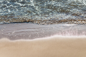 Soft wave of the sea on the sandy beach.Soft focus,blurred image.