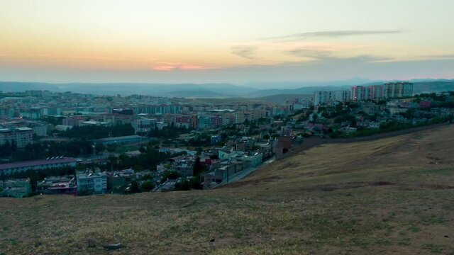 Siirt city in Turkey day to night timelapse with a view to the whole city during sunset.