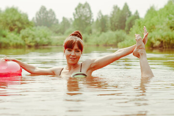 a girl poses standing in the river