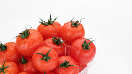 Fresh red tomatoes in container for delivery or sale on white background