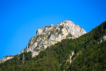 Mountain panorama at Lake Klöntal at a beautiful late summer morning. Photo taken September 4th, 2021, Klöntal, Switzerland.