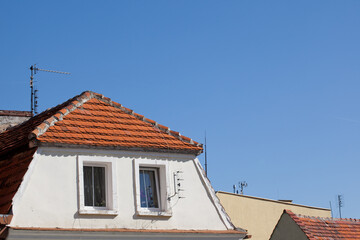 Townhouses with sloping roofs and mounted antennas.
