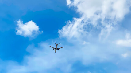 Blue sky with clouds and airplane landing. selective focus 