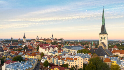 Fototapeta na wymiar Aerial panoramic view over medieval Old Tallinn cityline with the sunrise colored sky and Moon background