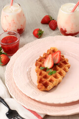 Croffle or  Croissant Waffle in Pink Plate. Croffle is Viral Cake from South Korea. Served with Korean Strawberry Milk