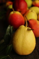 sweet and fragrant autumn pears on rustic black wooden table
