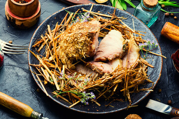 Roast pork in hay with herbs © nikolaydonetsk
