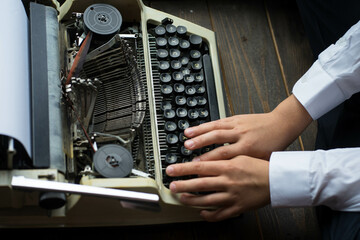 boy typing on a printing machine