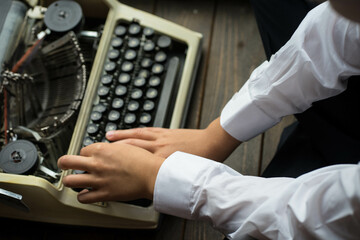 boy typing on a printing machine