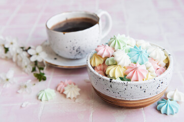 Cup with coffee and small meringues