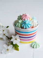 Small colorful meringues in the  paper bowl