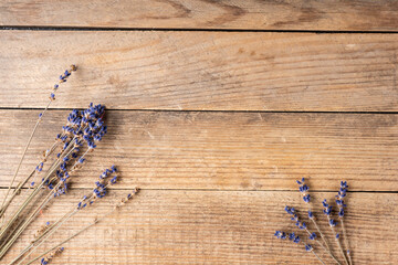Bunch of dried lavender flowers on the rustic wooden background. Shot from above.
