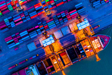 Aerial top view over international cargo ship at industrial import-export port prepare to load...