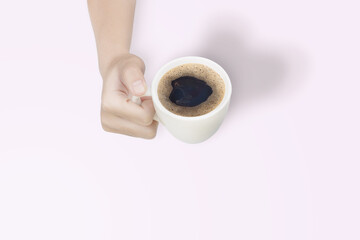 Woman holding hot cup of coffee, with shadow heart shape