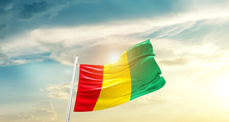 Guinea national flag cloth fabric waving on beautiful sky - Image