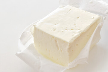 Feta cheese in an opened plastic packing.