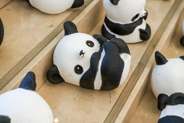 Close-up of a group of ceramic graffiti panda dolls