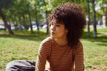 Cute young woman looking thoughtful outdoors