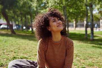 Smiling young woman looking away in a park
