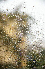 View through window with water drops at rainy weather