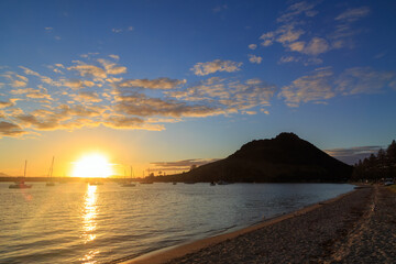 Fototapeta premium Mount Maunganui, New Zealand. Sunset over Pilot Bay Beach and Tauranga Harbour