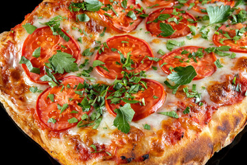 Pizza with tomatoes and parsley, 45 view. Macro
