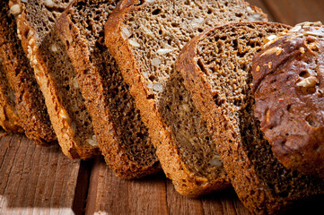 Bread made from natural products, on live sourdough, without baker's yeast, cut into skibbles on a wooden table surface.