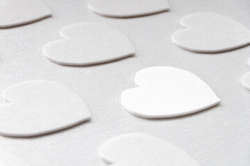 Simple white hearts on a white background