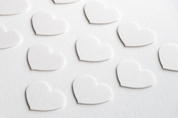 Simple white hearts on a white background