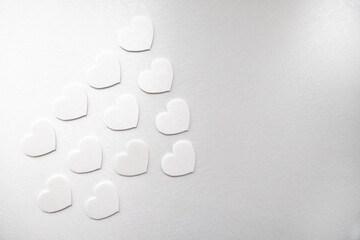 Simple white hearts on a white background