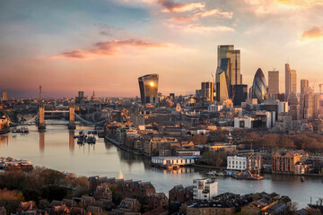 The skyline of London city with Tower Bridge and financial district skyscrapers during sunrise,...