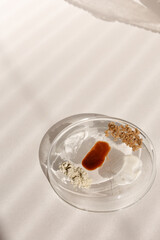 Homemade facial masks with ecological herbal ingredients on plate.